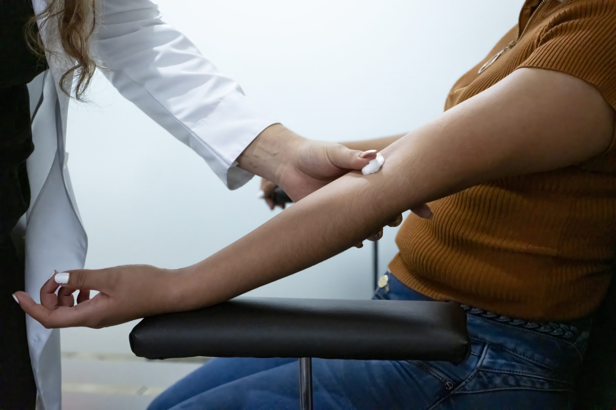 Nurse putting a cotton wool pad where draw blood